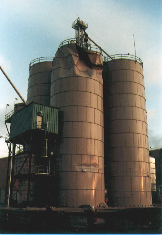 Buckled tall steel tank (a silo?)