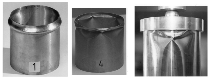 Buckled axially compressed clamped metallic cylindrical shells