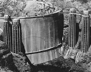 The upstream-side of the Hoover Dam is shown as it fills for the first time (1935)