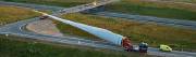 Two vehicles are required in order to negotiate sharp turns while moving a big wind turbine blade.