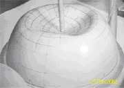 Rubber spherical shell under concentrated inward-directed load
