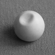 Ping pong ball with an axisymmetric buckle caused by a concentrated load
