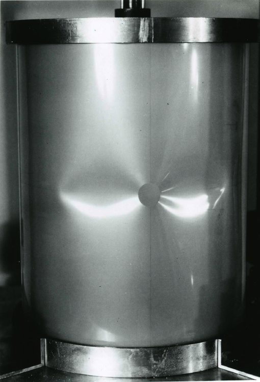 Local buckling of the axially compressed Mylar cylindrical shell with a small hole