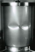 Local buckling of the axially compressed Mylar cylindrical shell with a small hole