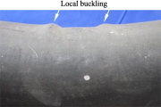Local buckling of laterally impacted concrete-filled tube